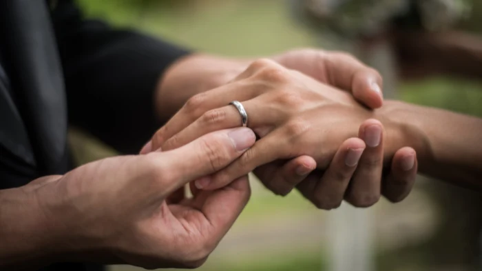 groom and bride with wedding ring representing spouse visa uk